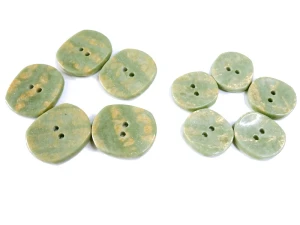 Guzik owalny, perłowy, płaski, kolor pistacjowo-złotawy, cieniowany - rozmiar : większy 22 x 19 mm, mniejszy 18 x 12 mm - cena za parę / duży i mały guzik